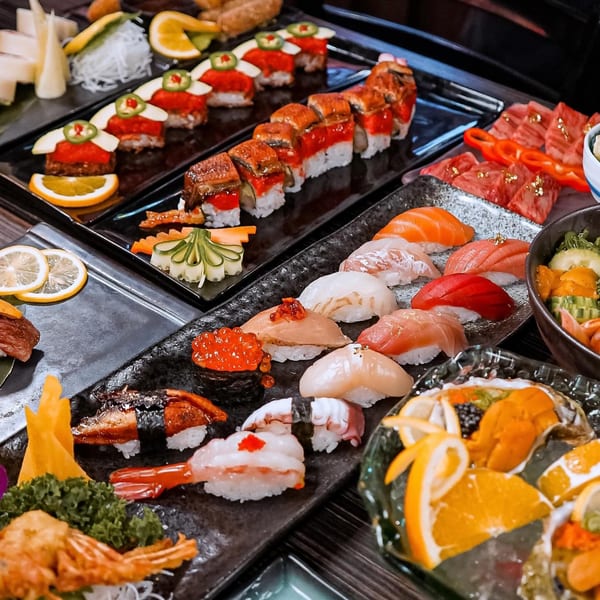 An abundant spread of various Sushiya sushi and sashimi, including nigiri, rolls, and raw fish.